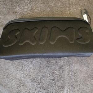 New skims make up bag. With tags. Never used. Measurements are shown.